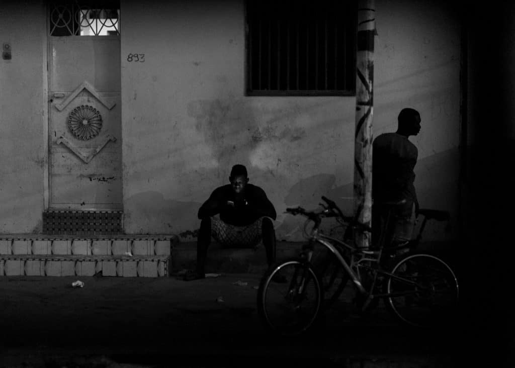 A young man reads something on his phone.