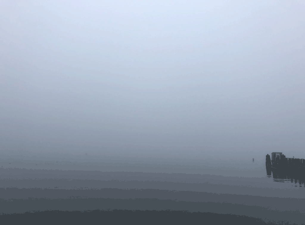 an image of a grey misty day where the ocean and sky appear as one matrix