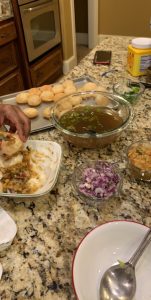Various foods are laid out on a granite counter.