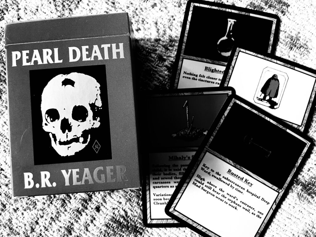 box labeled Pearl Death B R Yeager and cards displayed next to it