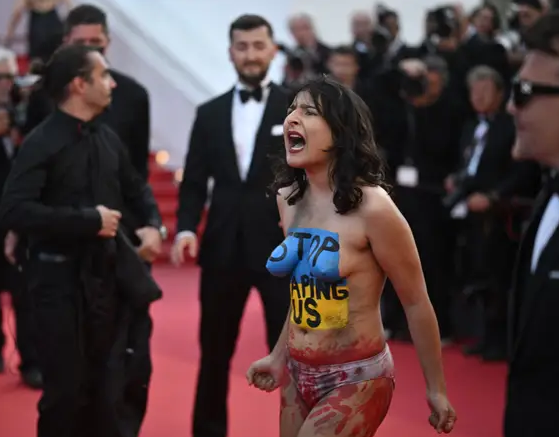 Nude woman in body paint protests Cannes
